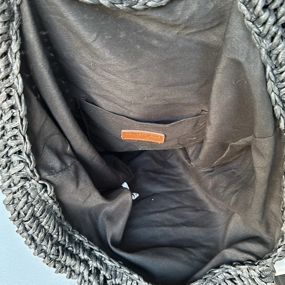 Kenneth Cole straw bag in back with tan straps